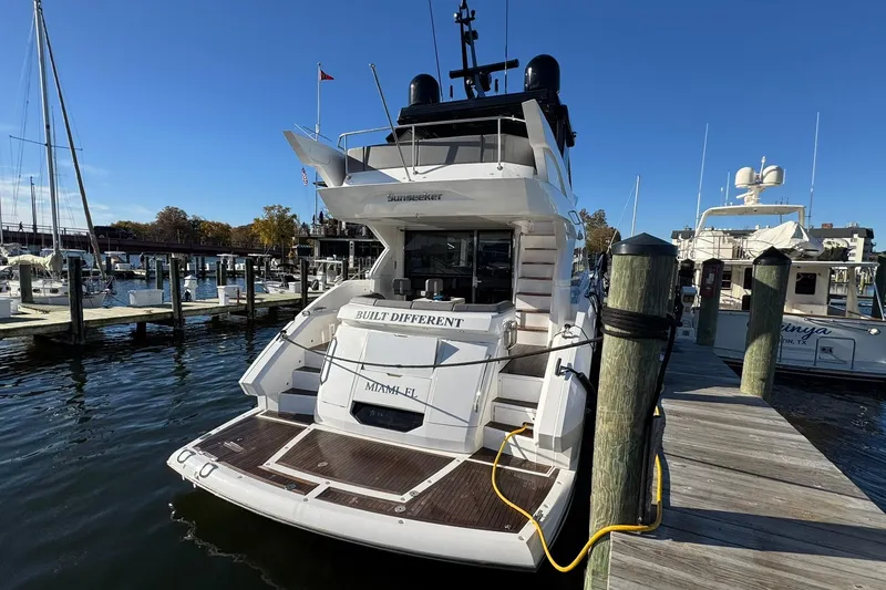 Slide: The Image of 2022 Sunseeker Manhattan 55 yacht docked at marina under clear blue sky. - 9