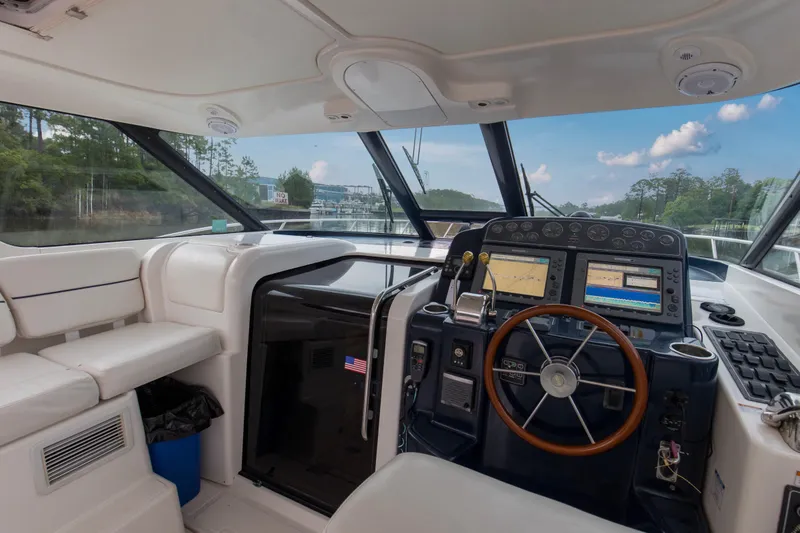 Slide: The Image of 2005 Tiara Yachts 3600 Sovran helm with navigation equipment and panoramic windows. - 16