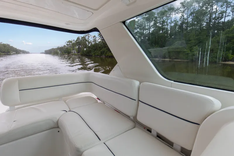 Slide: The Image of Interior view of 2005 Tiara Yachts 3600 Sovran, featuring white seating and scenic waterway. - 21