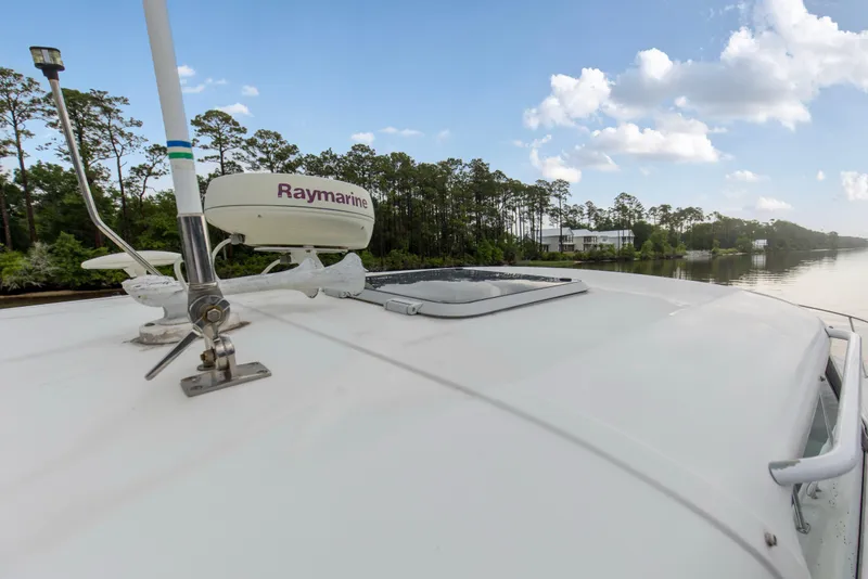 Slide: The Image of 2005 Tiara Yachts 3600 Sovran with Raymarine equipment on deck, near a scenic waterway. - 30