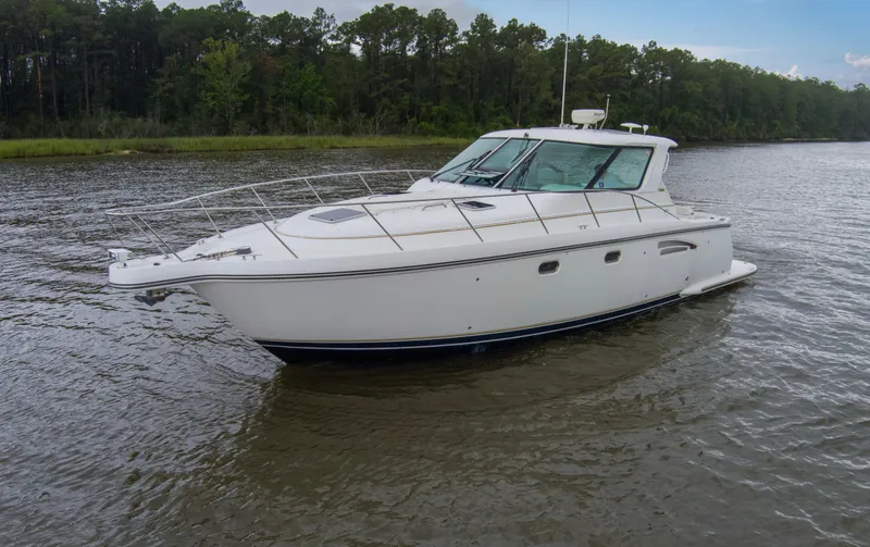 Slide: The Image of 2005 Tiara Yachts 3600 Sovran cruising on a calm river with forested background. - 38