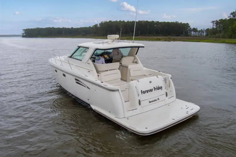 Slide: The Image of 2005 Tiara Yachts 3600 Sovran cruising on a calm river, rear view. - 41