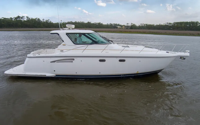 Slide: The Image of 2005 Tiara Yachts 3600 Sovran cruising on calm waters under a clear sky. - 42