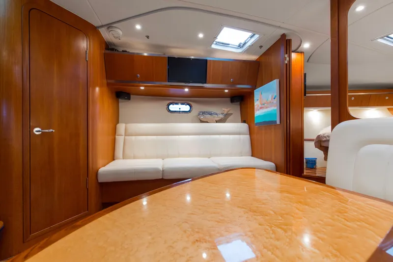 Slide: The Image of Interior of 2005 Tiara Yachts 3600 Sovran with wood finish and white seating. - 6