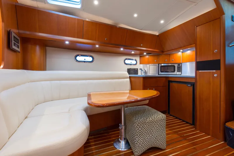 Slide: The Image of 2005 Tiara Yachts 3600 Sovran interior with kitchen, dining area, and wood finishes. - 7