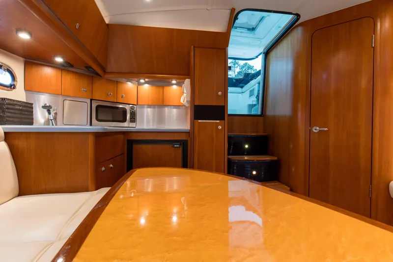 Slide: The Image of Interior of 2005 Tiara Yachts 3600 Sovran, featuring a modern kitchen and dining area. - 8