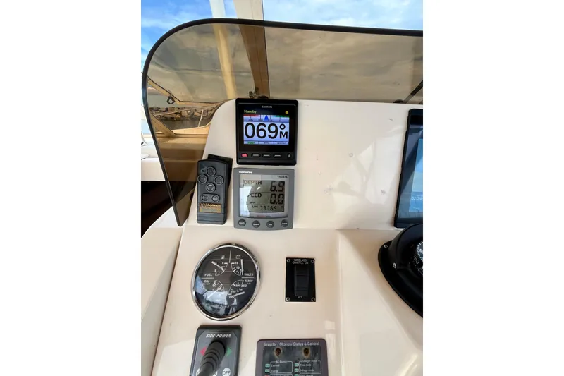 Slide: The Image of 2005 Mainship Pilot 30-II dashboard with navigation and control instruments. - 10