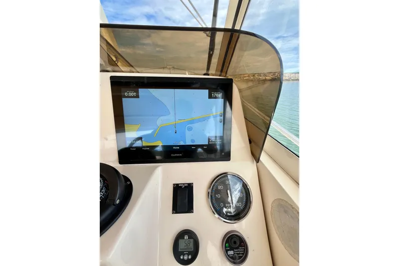 Slide: The Image of 2005 Mainship Pilot 30-II helm with Garmin navigation display and gauges. - 11