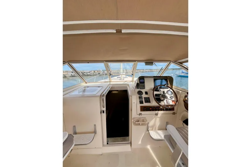 Slide: The Image of 2005 Mainship Pilot 30-II helm with steering wheel, navigation instruments, and sea view. - 13