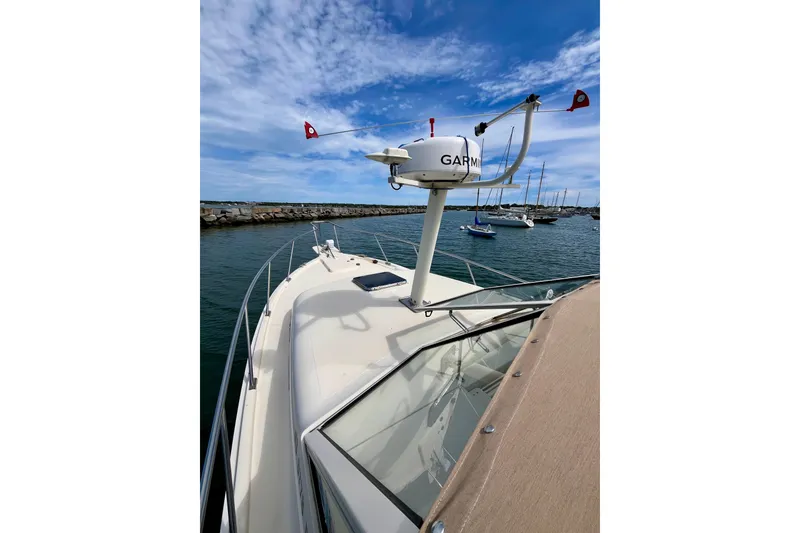Slide: The Image of 2005 Mainship Pilot 30-II boat with Garmin radar, docked in a marina under blue skies. - 24