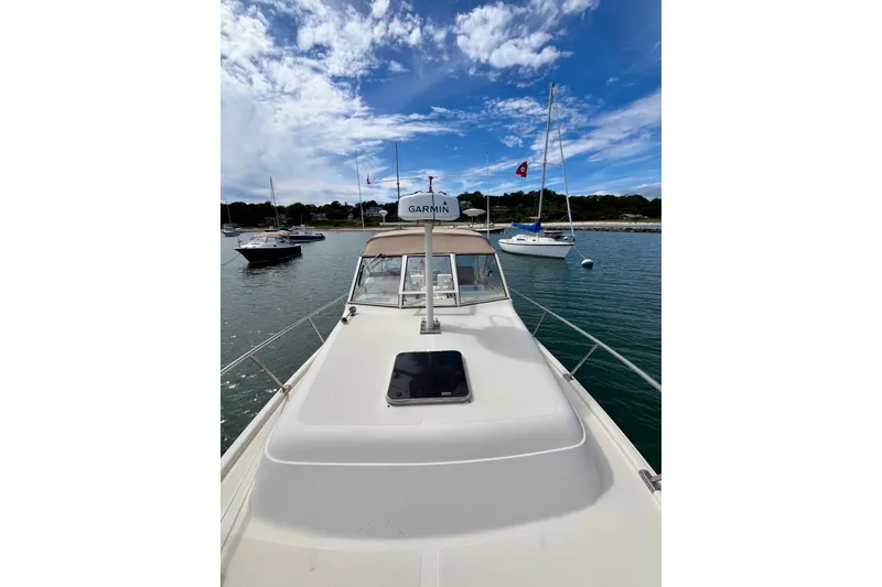 Slide: The Image of 2005 Mainship Pilot 30-II boat on water, clear sky, Garmin radar visible. - 25