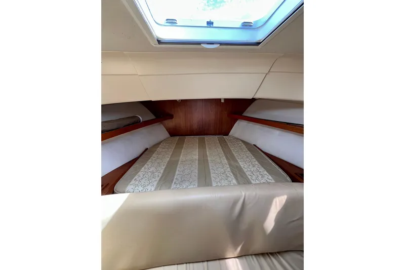 Slide: The Image of 2005 Mainship Pilot 30-II cabin interior with bed and skylight. - 39