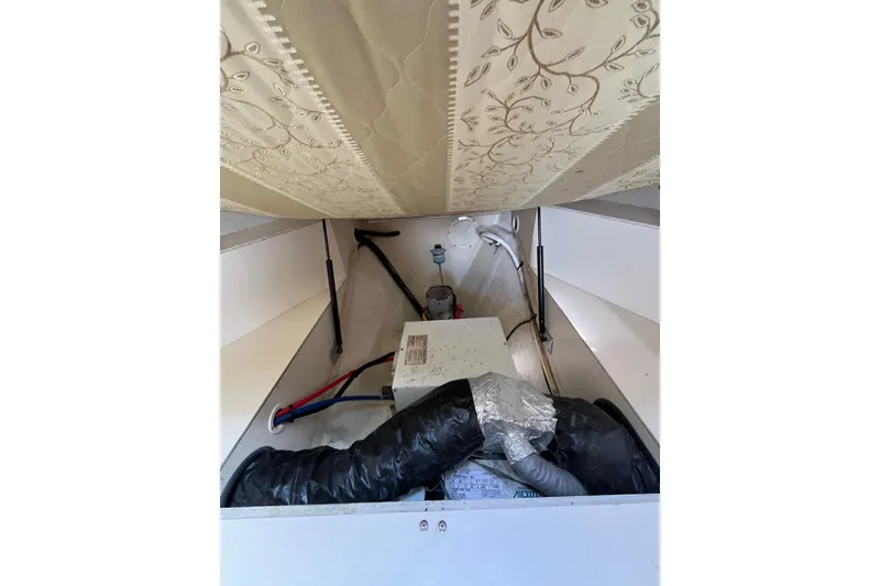 Slide: The Image of 2005 Mainship Pilot 30-II interior storage with pipes and equipment. - 40