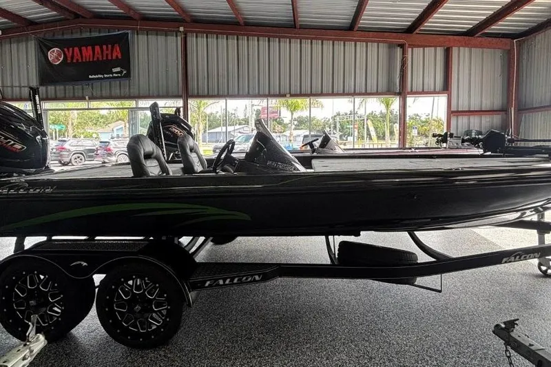 The Image of 2025 Falcon Boats 21 Predator in showroom, sleek design, on trailer. - 0