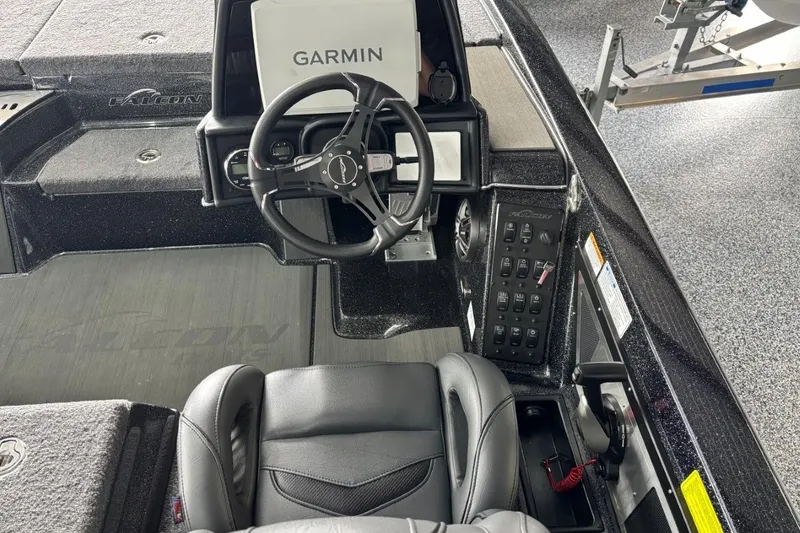Slide: The Image of 2025 Falcon Boats 21 Predator dashboard with Garmin navigation and sleek steering wheel. - 12
