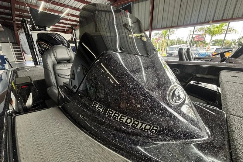 Slide: The Image of 2025 Falcon Boats 21 Predator with sleek design in showroom setting. - 17