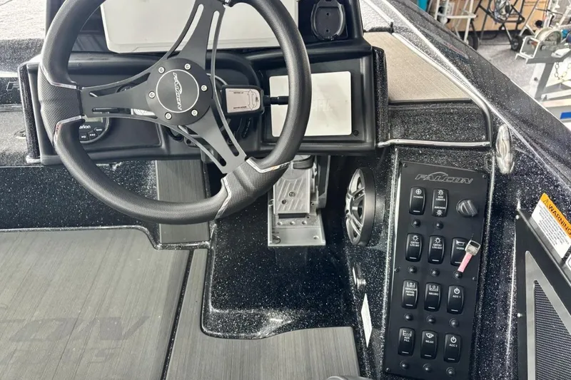 Slide: The Image of Steering console of 2025 Falcon Boats 21 Predator with control panel and switches. - 22
