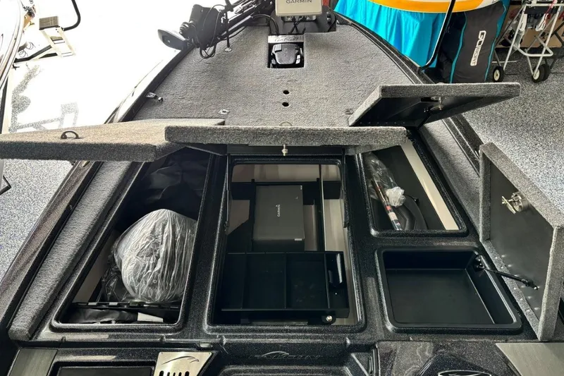 Slide: The Image of 2025 Falcon Boats 21 Predator interior storage compartments with open lids, showcasing organized space. - 25