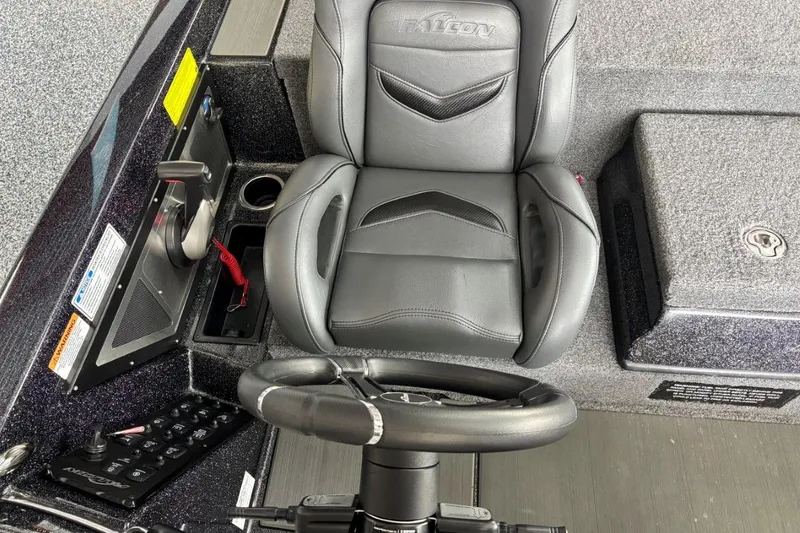 Slide: The Image of Captain's seat and controls of 2025 Falcon Boats 21 Predator, featuring sleek design and modern amenities. - 13