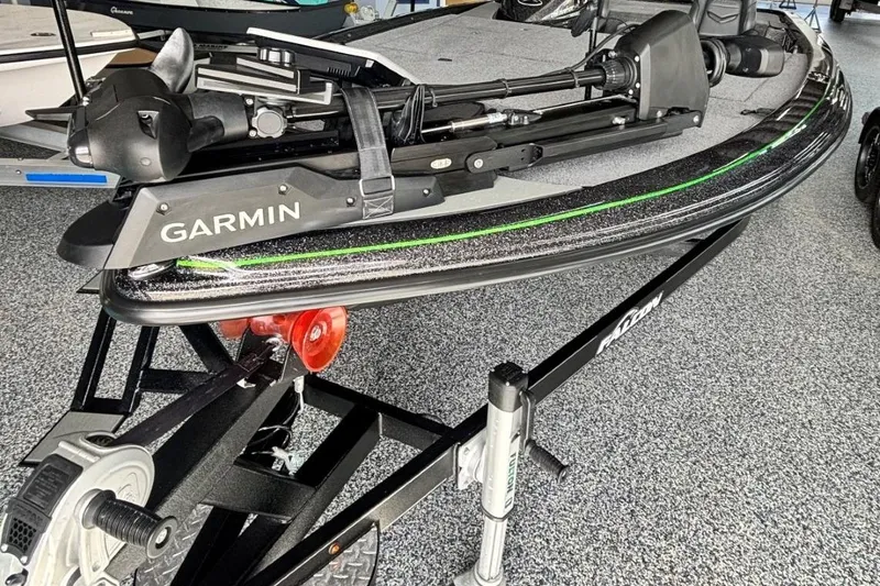 Slide: The Image of 2025 Falcon Boats 21 Predator with Garmin equipment on a trailer in a showroom. - 2