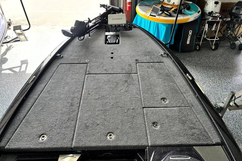 Slide: The Image of 2025 Falcon Boats 21 Predator deck with Garmin equipment in a garage setting. - 24