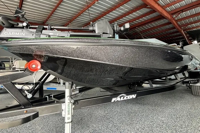 Slide: The Image of 2025 Falcon Boats 21 Predator on trailer, featuring sleek black hull and Garmin equipment. - 5