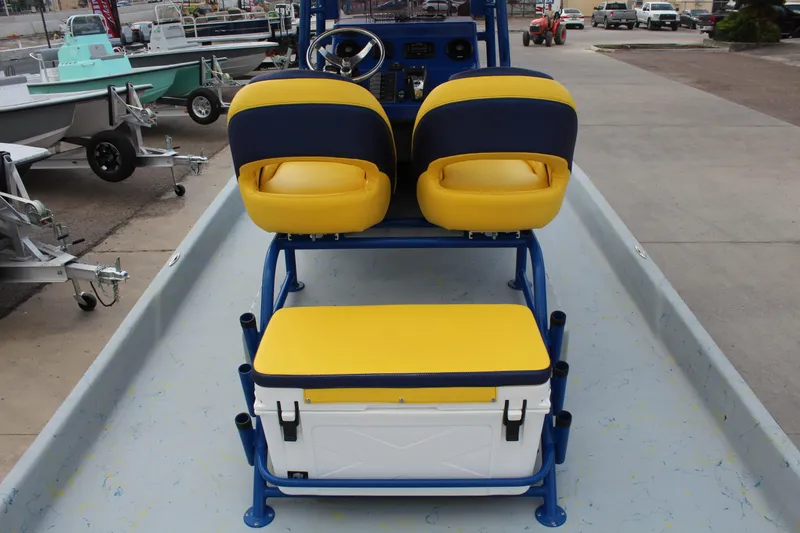 Slide: The Image of 2015 Shoalwater 23 Catamaran interior with yellow and blue seating and cooler. - 10