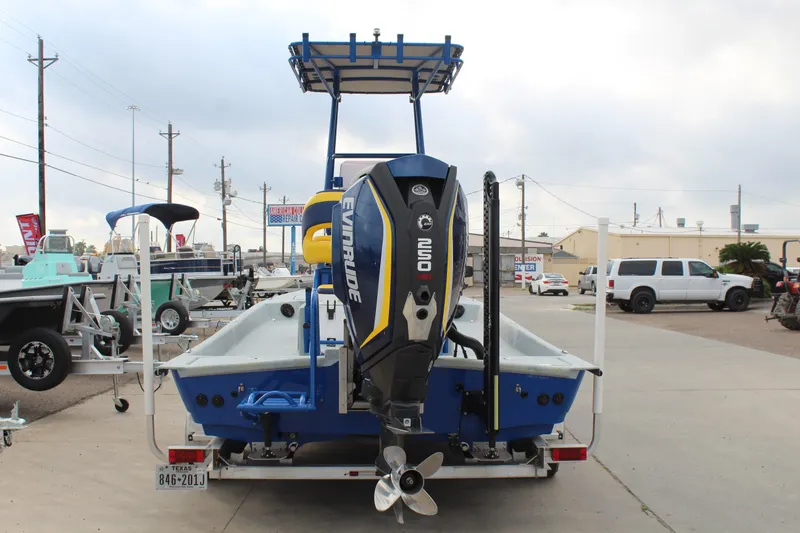 Slide: The Image of 2015 Shoalwater 23 Catamaran with Evinrude engine, parked on a trailer in a lot. - 6