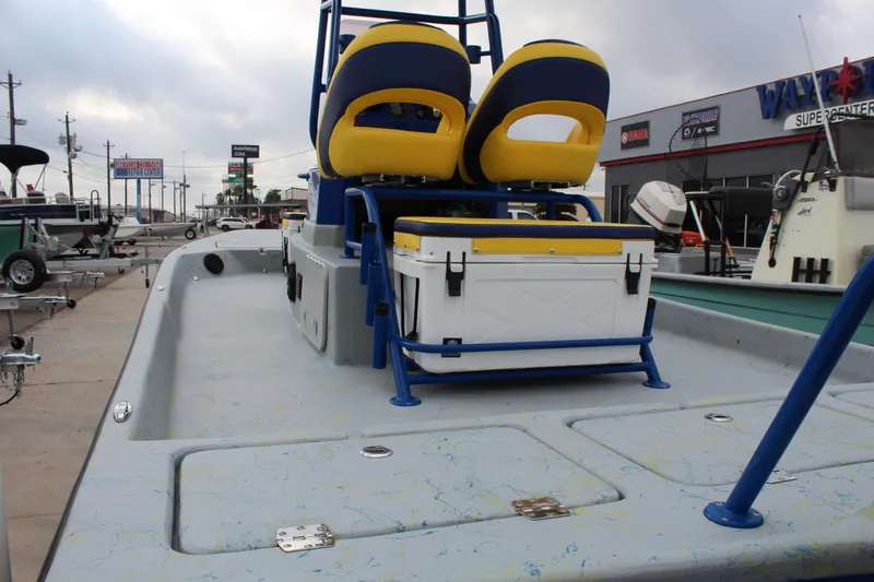 Slide: The Image of 2015 Shoalwater 23 Catamaran with dual seats and cooler on deck, parked at dealership. - 8