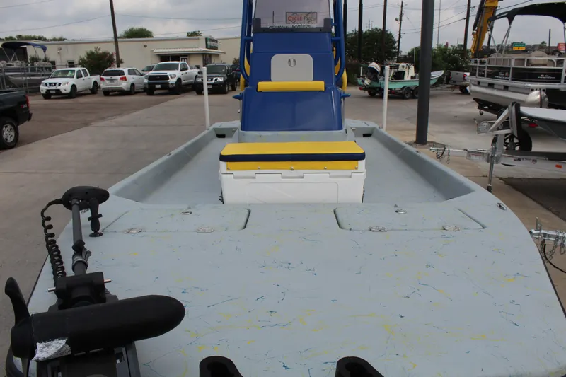 Slide: The Image of 2015 Shoalwater 23 Catamaran boat with blue and yellow seating, parked in a lot. - 9