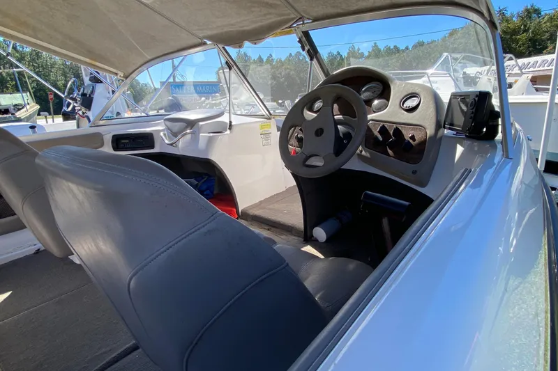 Slide: The Image of 2001 ProCraft 180 Combo boat interior with steering wheel and dashboard controls. - 12