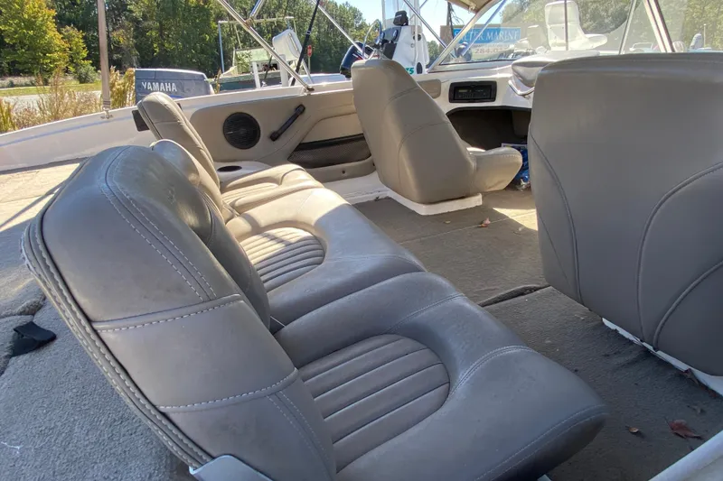 Slide: The Image of Interior of 2001 ProCraft 180 Combo boat with gray seating and steering area. - 13