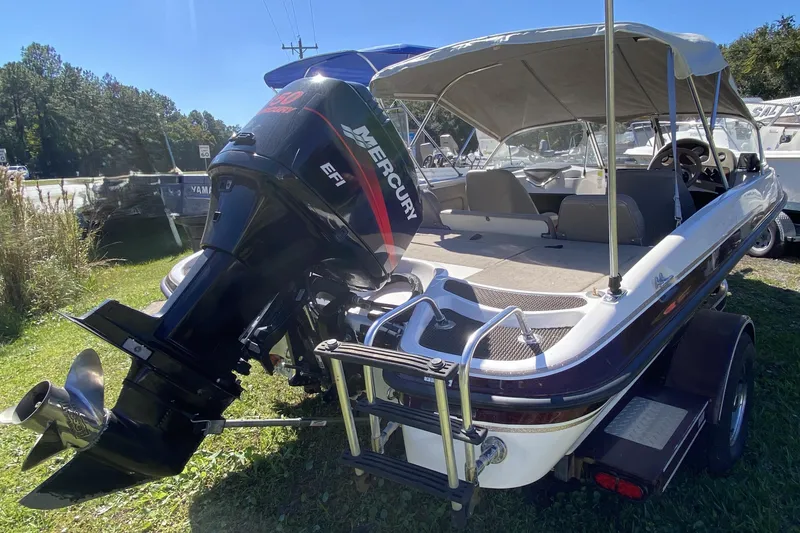 Slide: The Image of 2001 ProCraft 180 Combo boat with Mercury EFI outboard motor, parked on grass. - 3