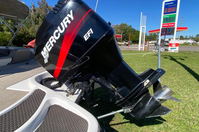 Slide: The Image of 2001 ProCraft 180 Combo boat with Mercury EFI engine at a gas station. - 5