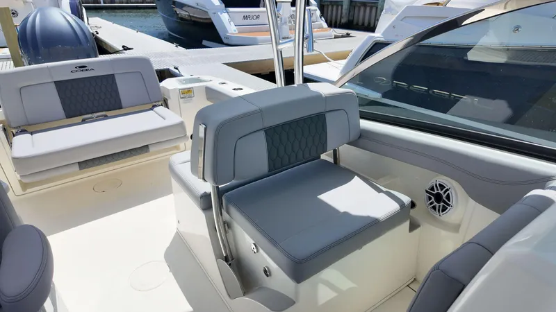 Slide: The Image of 2025 Cobia 240 Dual Console boat anchor compartment at marina. - 13