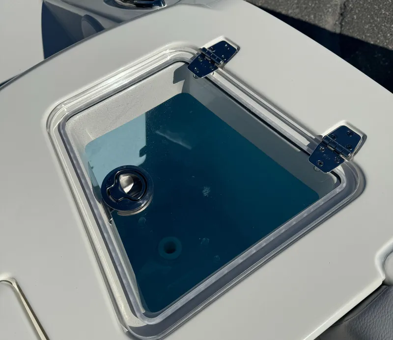 Slide: The Image of 2025 Cobia 240 Dual Console boat interior with helm, seating, and storage compartments. - 5