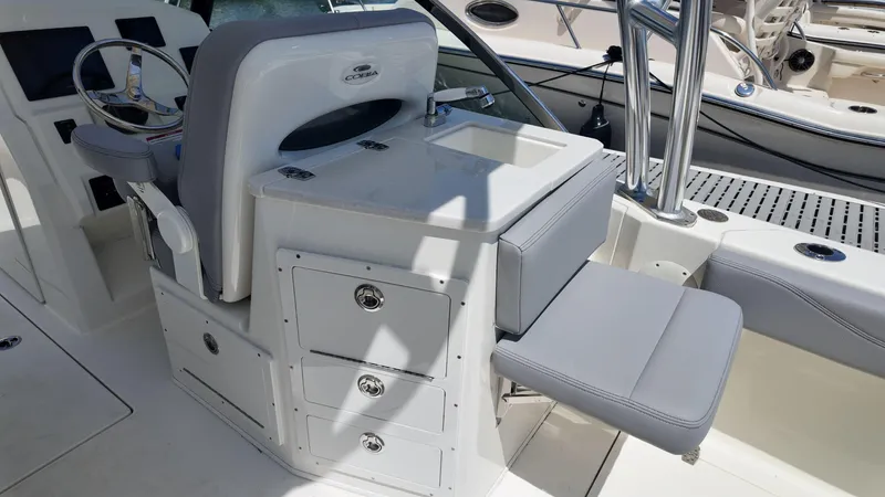Slide: The Image of 2025 Cobia 240 Dual Console boat interior with Garmin navigation and comfortable seating. - 6