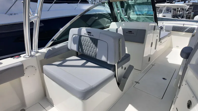 Slide: The Image of 2025 Cobia 240 Dual Console boat interior with comfortable seating and speaker system. - 7