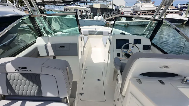 Slide: The Image of 2025 Cobia 240 Dual Console boat helm with Garmin navigation system. - 8