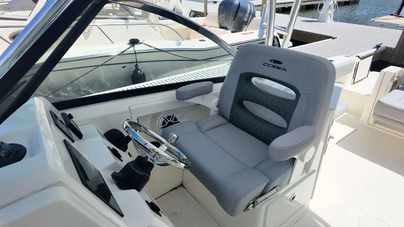 Slide: The Image of Steering console of 2025 Cobia 240 Dual Console boat with Garmin and Yamaha controls. - 9