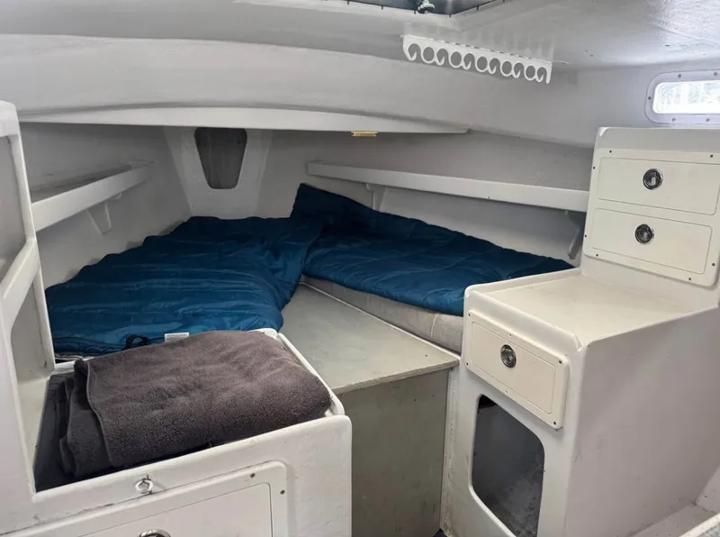 Slide: The Image of Interior of 1990 South Shore 30 Downeast boat with cozy sleeping area and storage. - 13