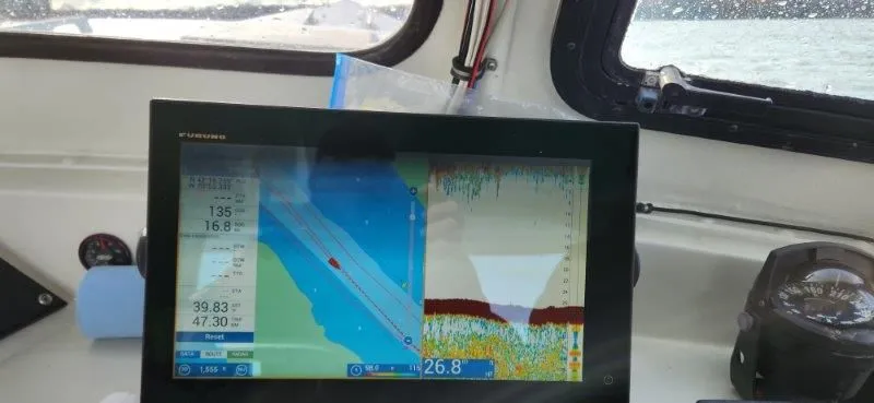 Slide: The Image of Navigation system on a 1990 South Shore 30 Downeast boat, displaying marine charts and sonar data. - 14