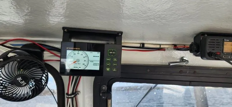 Slide: The Image of Interior of 1990 South Shore 30 Downeast boat with navigation equipment and fan. - 15