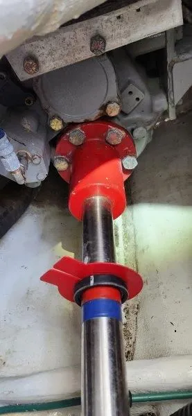 Slide: The Image of Engine component of a 1990 South Shore 30 Downeast boat, featuring a red coupling and metal shaft. - 21