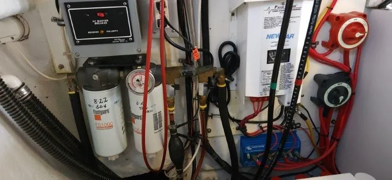 Slide: The Image of Engine room of a 1990 South Shore 30 Downeast boat with wiring and filters. - 22