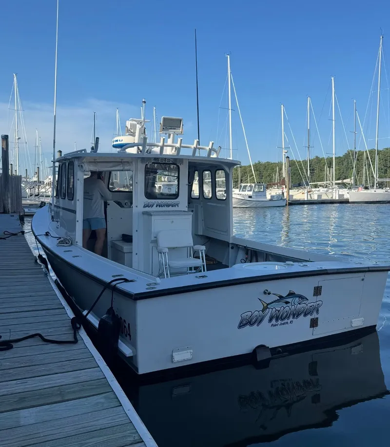 Slide: The Image of South Shore 30 Downeast boat docked at marina, 1990 model, clear blue sky. - 3