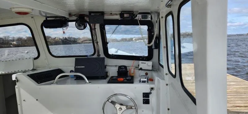 Slide: The Image of Interior view of a 1990 South Shore 30 Downeast boat, featuring navigation equipment and a steering wheel. - 6