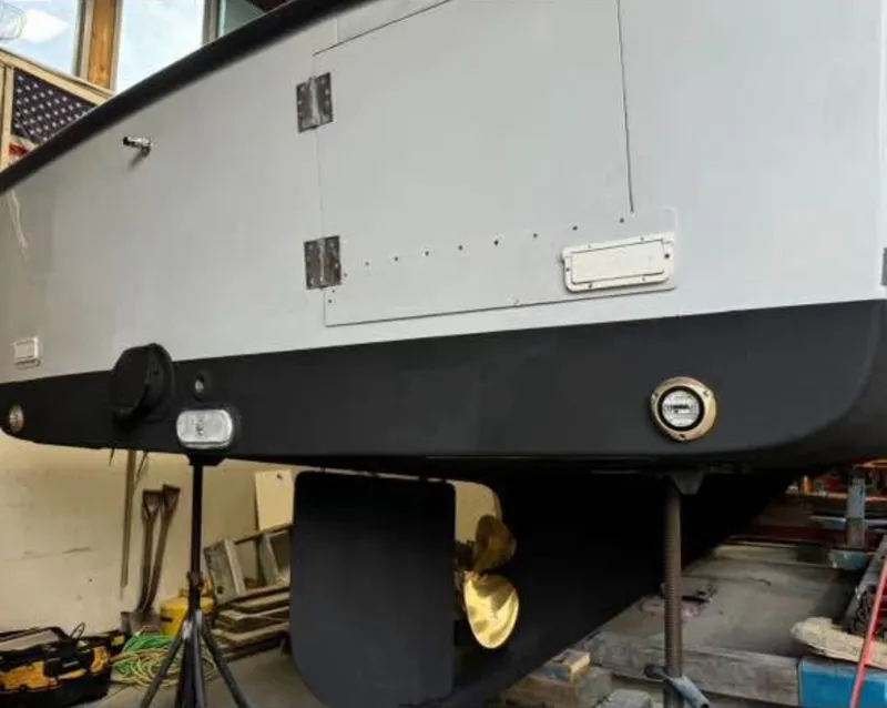 Slide: The Image of 1990 South Shore 30 Downeast boat in a workshop, showing hull and propeller. - 9