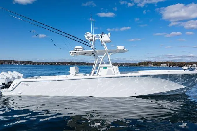 The Image of 2016 SeaVee 390Z boat on calm water under a clear blue sky. - 0