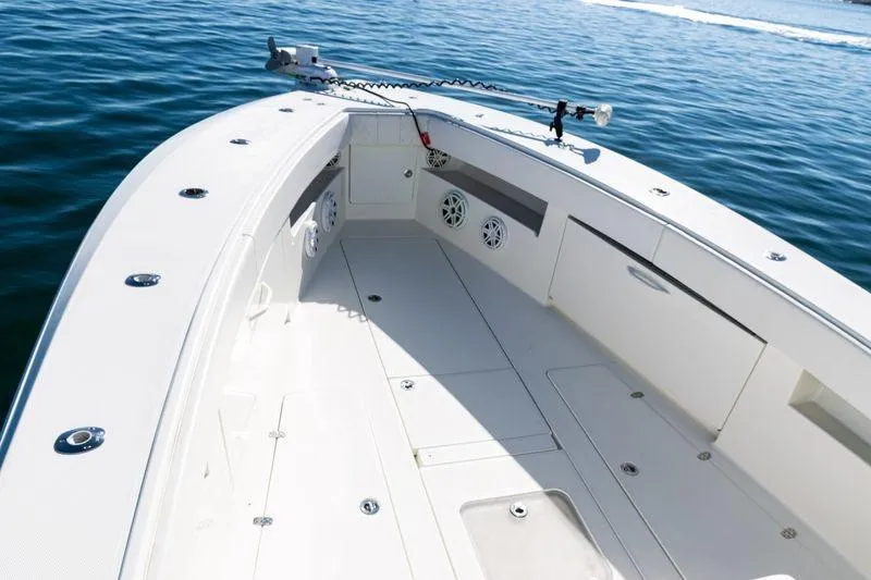 Slide: The Image of 2016 SeaVee 390Z boat deck with storage compartments and speakers on calm water. - 15